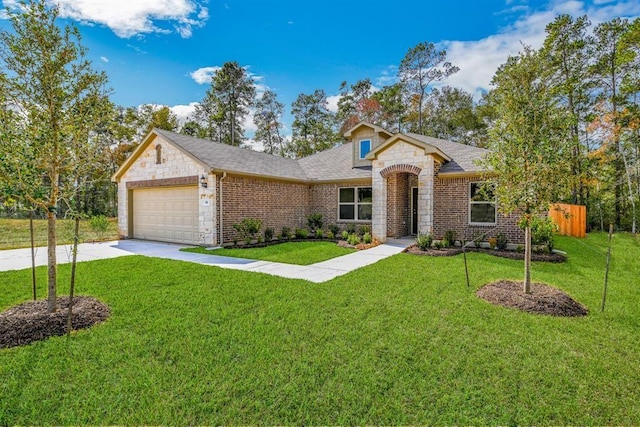 view of front facade featuring a garage, stone siding, a front yard, and driveway