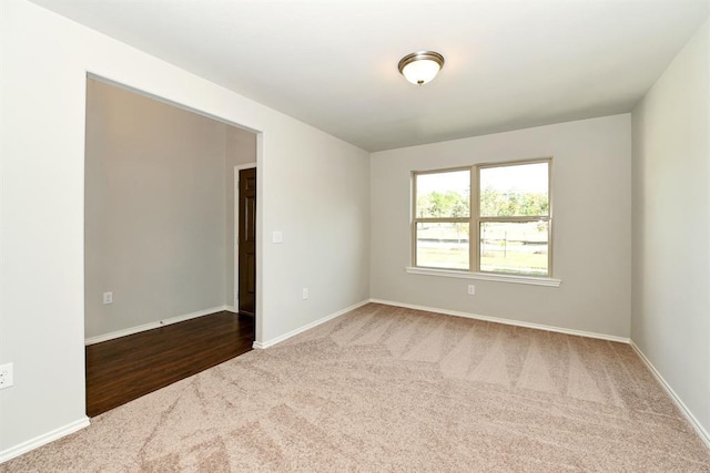 spare room with carpet and baseboards