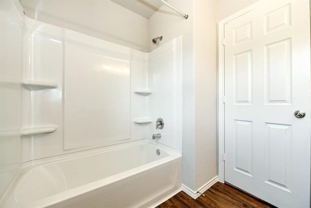 full bathroom featuring tub / shower combination, baseboards, and wood finished floors