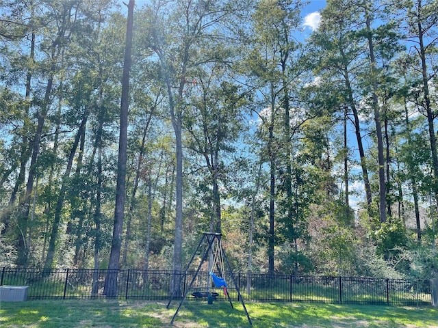 view of yard featuring a playground and fence