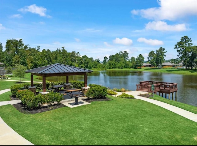 view of community featuring a gazebo, a lawn, and a water view