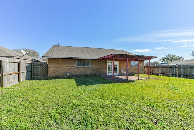 back of house featuring a patio, a fenced backyard, brick siding, french doors, and a lawn