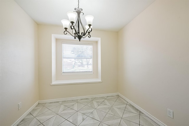 unfurnished dining area featuring a chandelier, light tile patterned floors, and baseboards