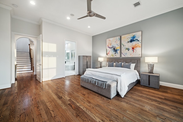 bedroom with arched walkways, visible vents, ornamental molding, wood finished floors, and baseboards