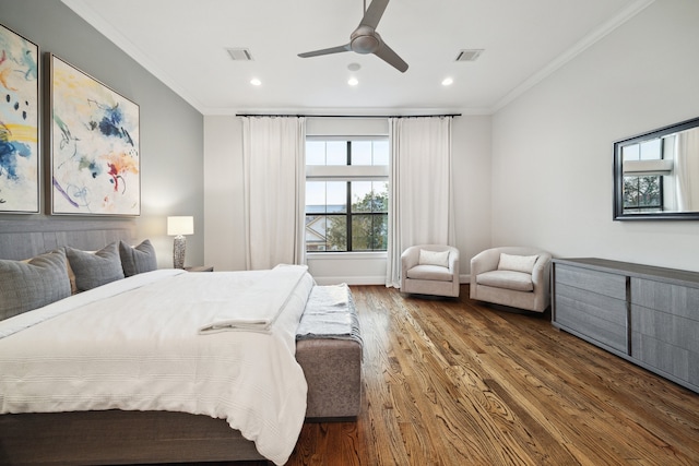 bedroom featuring visible vents, wood finished floors, and ornamental molding