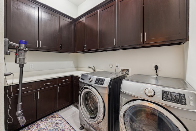 laundry room with cabinet space, independent washer and dryer, a sink, and light tile patterned flooring