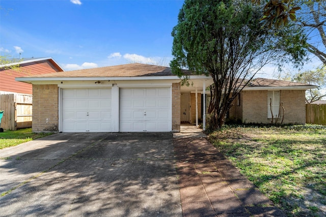 single story home with brick siding, concrete driveway, a garage, and fence