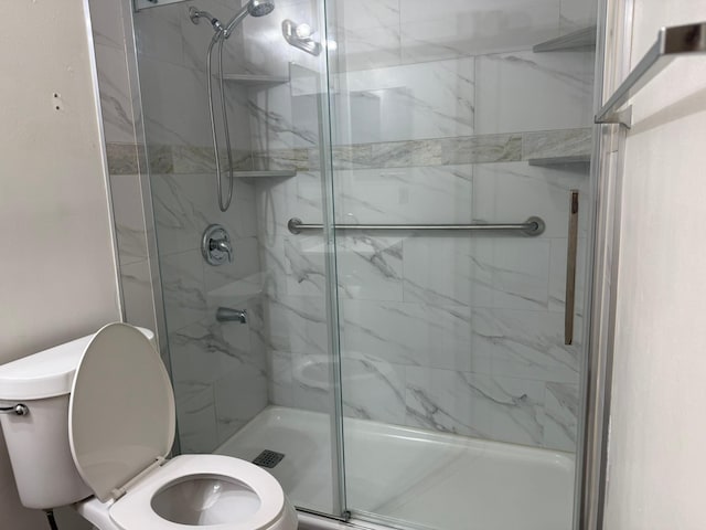 full bathroom with a stall shower and toilet