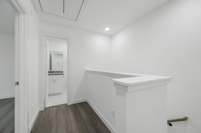 corridor featuring recessed lighting, dark wood-style flooring, an upstairs landing, baseboards, and attic access