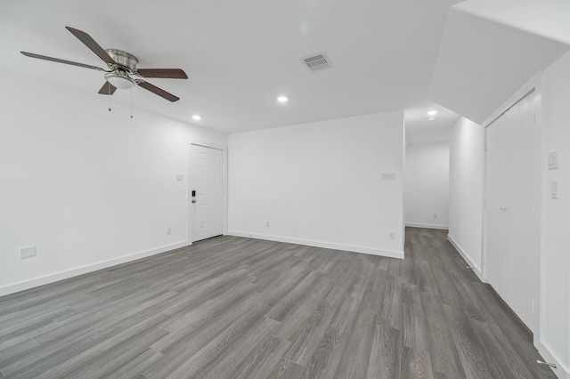 unfurnished room with ceiling fan, recessed lighting, wood finished floors, visible vents, and baseboards