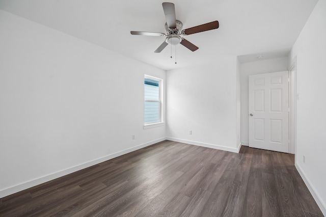 empty room featuring dark wood finished floors, baseboards, and ceiling fan