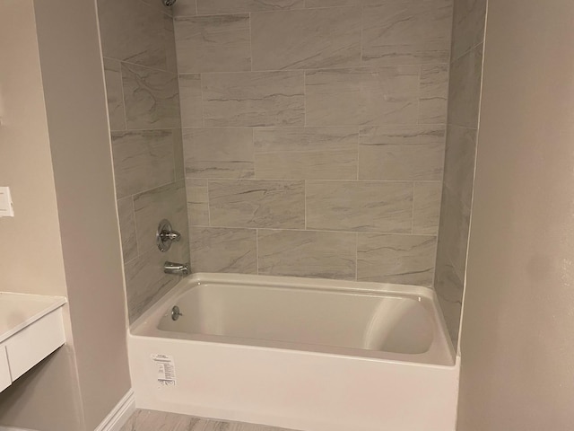 bathroom featuring shower / bathing tub combination and baseboards