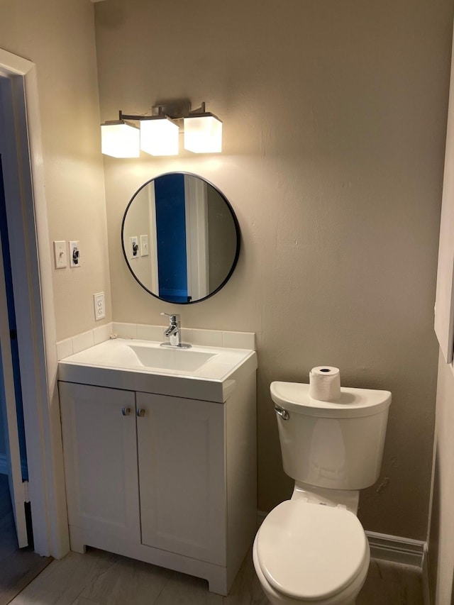 bathroom featuring vanity and toilet