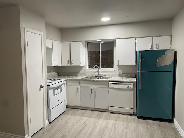 kitchen featuring light countertops, white appliances, a sink, and white cabinetry