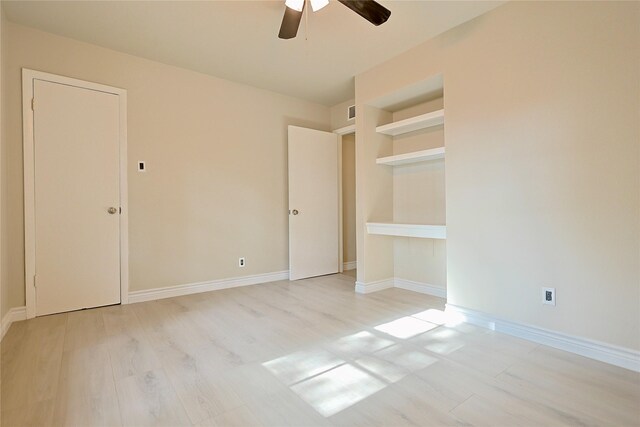 unfurnished bedroom with baseboards, ceiling fan, light wood-type flooring, and visible vents