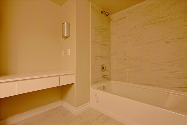 bathroom with shower / bathtub combination and baseboards