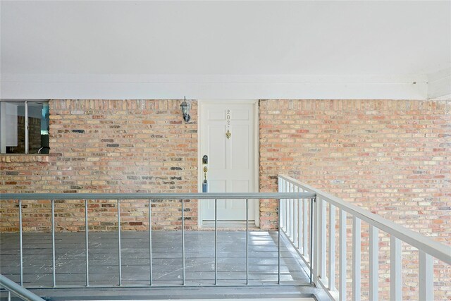 entrance to property featuring brick siding