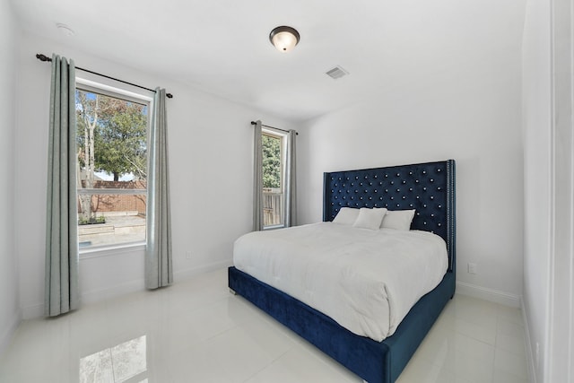 bedroom featuring visible vents, baseboards, and tile patterned floors