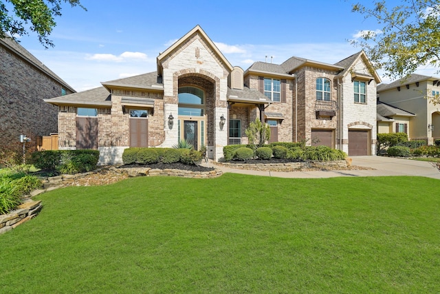 view of front of property featuring a garage, concrete driveway, a front lawn, and brick siding