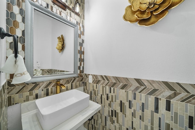 bathroom with a sink and tile walls