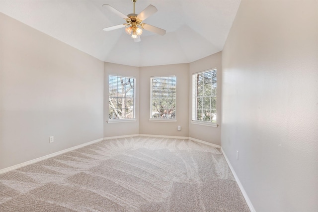 empty room featuring a ceiling fan, baseboards, and carpet flooring