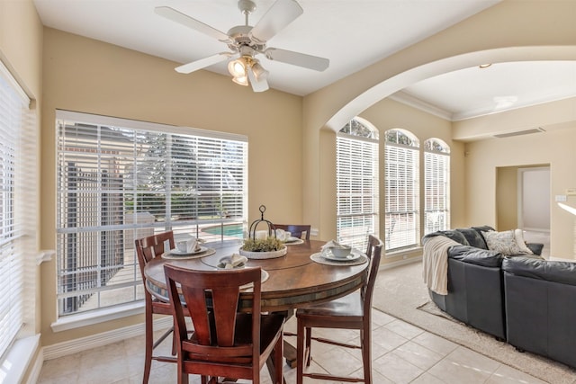 dining room with a ceiling fan, arched walkways, visible vents, and light tile patterned floors