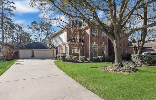 view of front of house with brick siding, a front lawn, a detached garage, and an outdoor structure