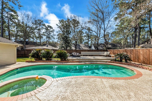 view of swimming pool with an outdoor living space, a patio area, a pool with connected hot tub, and a fenced backyard