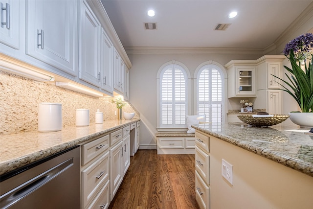 kitchen with visible vents, dark wood-type flooring, tasteful backsplash, crown molding, and light stone countertops