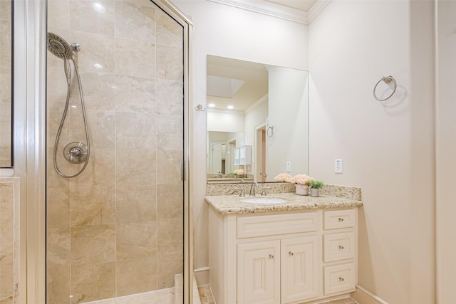 bathroom with a stall shower, vanity, and ornamental molding