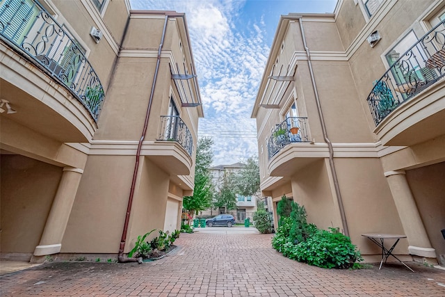 view of home's community featuring decorative driveway