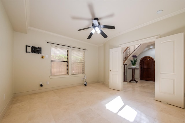 empty room featuring stairway, baseboards, ornamental molding, and a ceiling fan