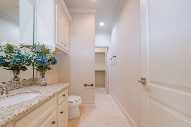 bathroom with vanity, baseboards, recessed lighting, crown molding, and toilet