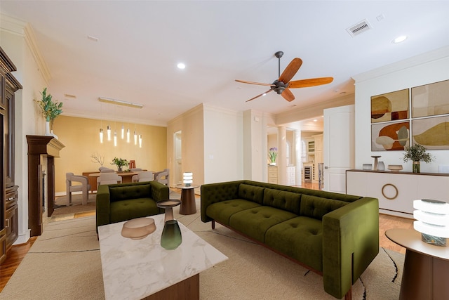 living area featuring crown molding, recessed lighting, visible vents, and ceiling fan