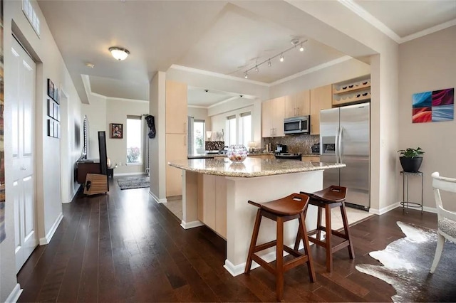 kitchen featuring dark wood-style floors, a kitchen island, stainless steel appliances, and backsplash