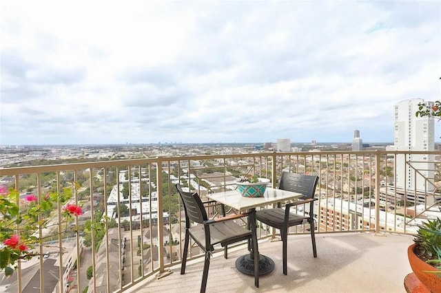 balcony featuring a view of city and outdoor dining area