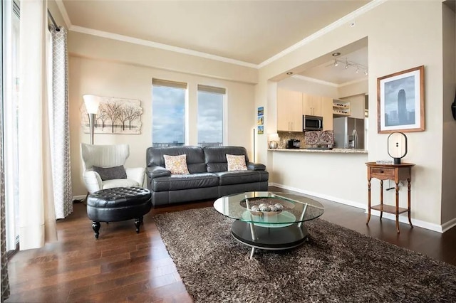 living room with dark wood-type flooring, crown molding, and baseboards