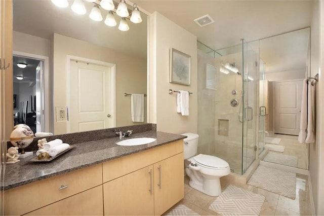 bathroom with visible vents, toilet, a stall shower, vanity, and tile patterned flooring