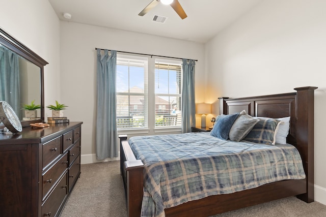 carpeted bedroom featuring ceiling fan, visible vents, and baseboards