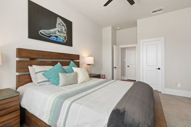 carpeted bedroom featuring a ceiling fan, visible vents, and baseboards