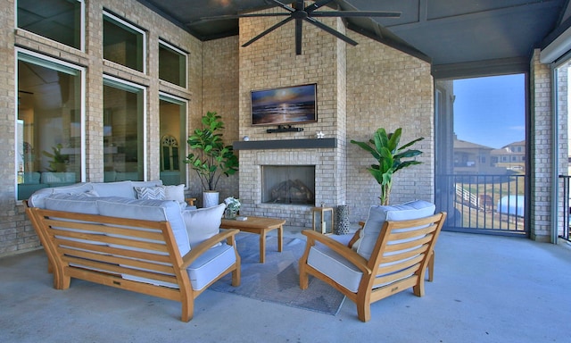 view of patio featuring a ceiling fan and an outdoor living space with a fireplace