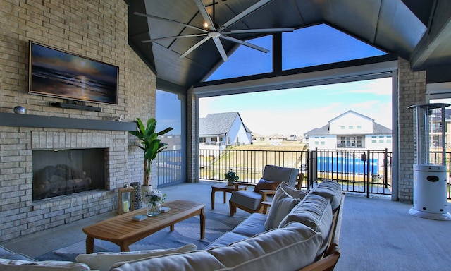 living room with beam ceiling, high vaulted ceiling, a ceiling fan, carpet flooring, and an outdoor brick fireplace