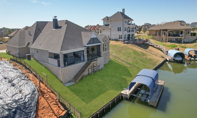 rear view of property with central AC, a water view, fence, a residential view, and a chimney