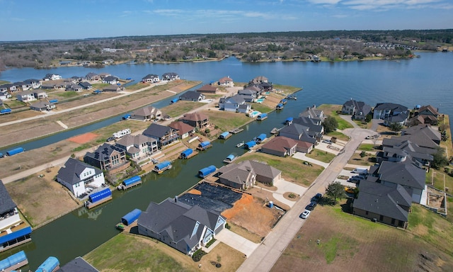 bird's eye view featuring a water view and a residential view