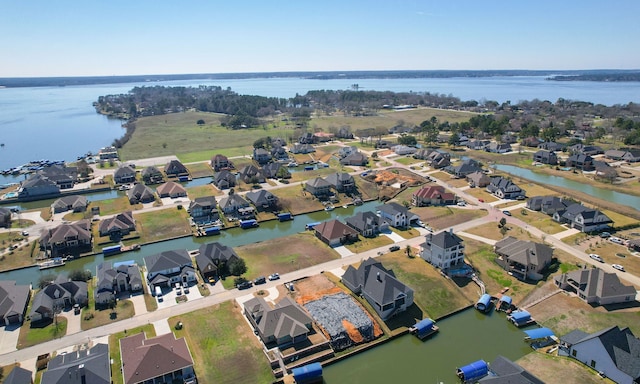 birds eye view of property with a water view and a residential view