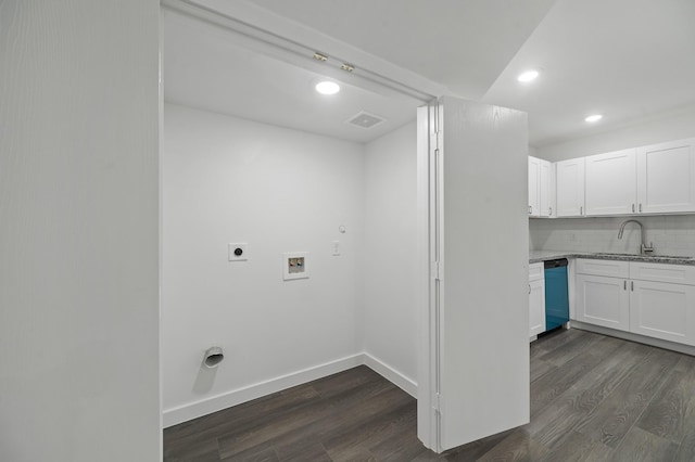 clothes washing area featuring laundry area, washer hookup, a sink, dark wood finished floors, and electric dryer hookup