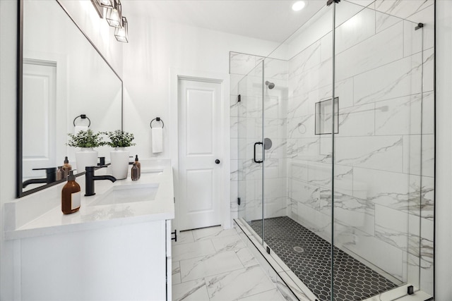 bathroom with recessed lighting, a sink, marble finish floor, a marble finish shower, and double vanity