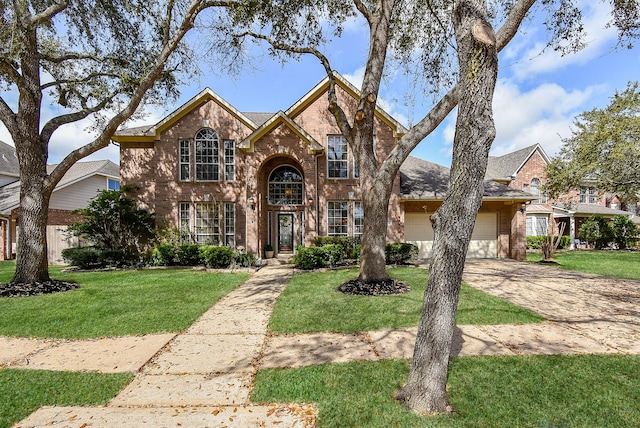 traditional home with a garage, brick siding, concrete driveway, and a front lawn