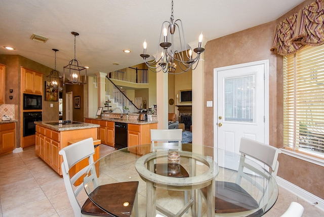 dining area featuring light tile patterned floors, visible vents, stairs, and an inviting chandelier