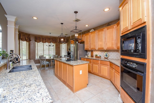 kitchen featuring backsplash, a kitchen island, light stone counters, black appliances, and a sink